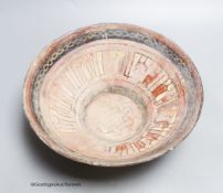 An Islamic bowl with kufic script, diameter 24cm