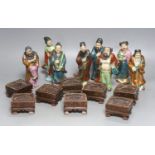 A set of eight 20th century Chinese porcelain figures of immortals, 15cm, each on carved wood stand