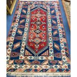 A Caucasian design blue ground rug, 240 x 152cm