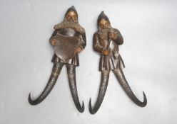 Two Black Forest chamois antler whip hooks, each with carved wood figural 'gnome' surmount,one