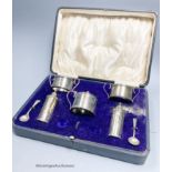 A cased George V silver five piece condiment set and two spoon, Birmingham, 1912.