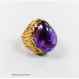 A pierced 585 yellow metal and large cabochon amethyst set dress ring, size K/L, gross 17.4 grams.