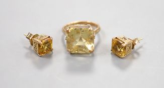A yellow metal and citrine set dress ring, size K and a pair of similar ear studs, gross weight 10