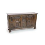 A late 16th/early 17th century German oak side cupboardWith plank to top and panelled triple door