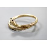 A mid 20th century 9ct gold coiled serpent bracelet, with gem set eyes, gross weight 22.4 grams (