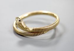 A mid 20th century 9ct gold coiled serpent bracelet, with gem set eyes, gross weight 22.4 grams (