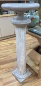 A white marble tazza on associated column stand120cm high (combined) 43cm diameter (tazza)