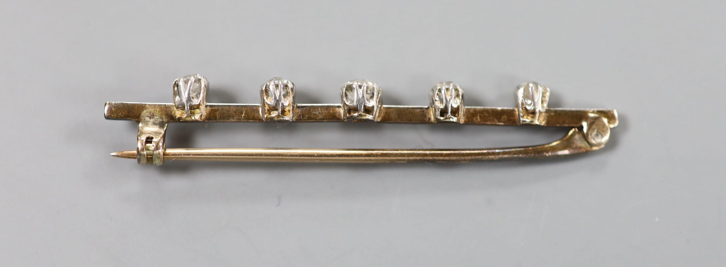 A yellow metal and graduated five stone diamond set bar brooch, 50mm, gross weight 3.7 grams. - Image 2 of 2