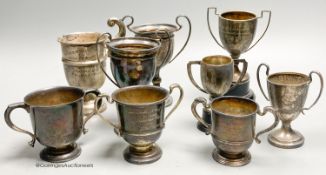 Eight assorted small silver trophy cups and one plated cup, tallest 11.3cm, 11.5oz.