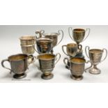 Eight assorted small silver trophy cups and one plated cup, tallest 11.3cm, 11.5oz.