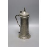 A Charles II pewter flagon, c.1675, with domed lid and turned finial and bifurcated thumbpiece,