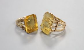 Two yellow metal and citrine set dress rings, one faintly marked 9ct, sizes L/M & P, gross weight
