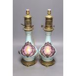 A pair of Napoleon III late 19th century porcelain and ormolu mounted oil lamps, height 40cm