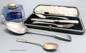 A silver mounted glass inkwell, two silver spoons and a silver Christening set.