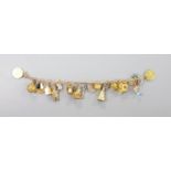 A 9ct charm bracelet, hung with assorted charms, gross weight 38.1 grams.