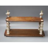 A Continental mahogany and floral encrusted porcelain two tier wall shelf