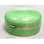 A 1920's continental silver and green guilloche enamel circular box and cover, with mirrored