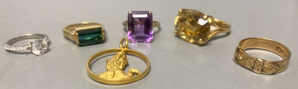 A Victorian 15ct gold buckle ring, size P/Q, 4.2 grams, three yellow metal and gem set dress rings,