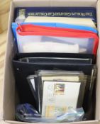 A collection of stamps and coins, including first day covers,