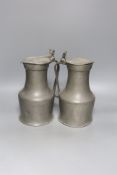 An 18th century French lidded pewter jug with double acorn thumbpiece and another similar jug,