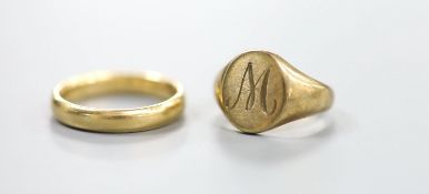 A 9ct gold signet ring, size E, 4.4 grams and an 18ct wedding band, 4 grams.