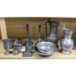 A French lidded pewter jug with double acorn thumbpiece, two pairs of pewter candlesticks and nine