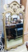 A George I style gilt composition wall mirror, having arched rectangular plate and shaped frame,