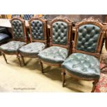 A set of twelve Victorian carved oak buttoned back and seat dining chairs