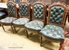 A set of twelve Victorian carved oak buttoned back and seat dining chairs