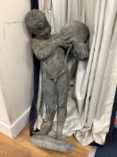 A lead figure of a boy carrying a water pitcher (a.f.),