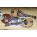 Three Neapolitan mandolins with inlaid mother of pearl decoration, one of round-backed form, the