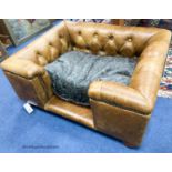An Italian buttoned tan leather dog's bed with loose cushion, width 84cm, depth 68cm, height 36cm