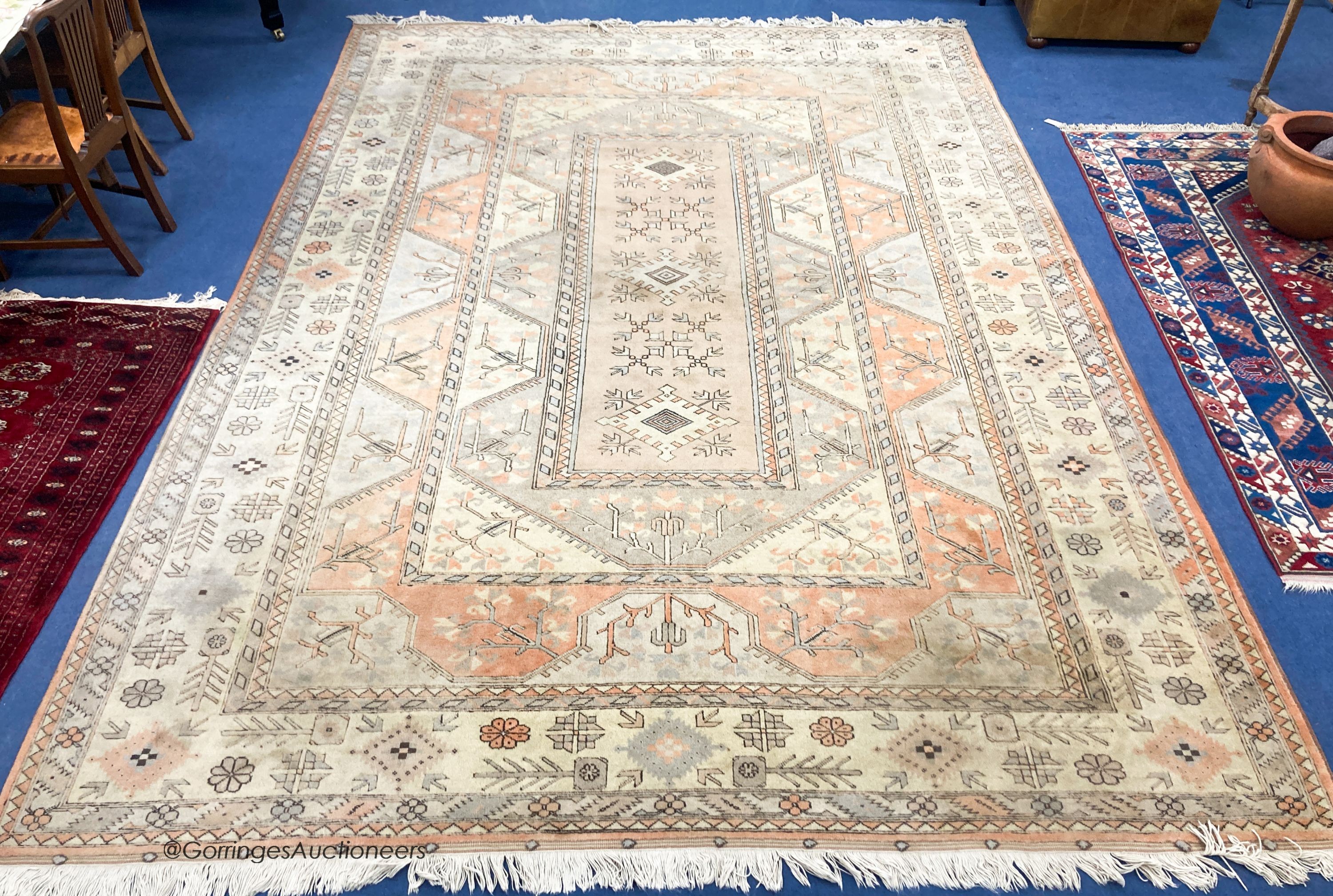 A large Caucasian Turkish design fawn ground carpet, 420 x 300cm