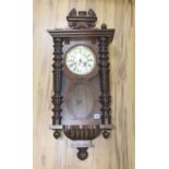 A 19th century Continental wall clock, in architectural walnut case, with key and pendulum, 95cm