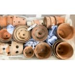 Approximately twenty six terracotta orchid pots, some stamped Sankey's Ltd, in assorted sizes,