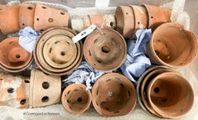 Approximately twenty six terracotta orchid pots, some stamped Sankey's Ltd, in assorted sizes,