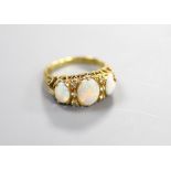 A 1970's Victorian style 18ct gold and graduated three stone white opal half hoop ring, with