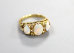 A 1970's Victorian style 18ct gold and graduated three stone white opal half hoop ring, with