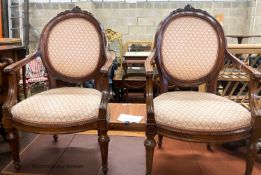 A pair of 19th century French walnut upholstered elbow chairs, W.62cm D.50cm H.102cm