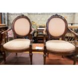 A pair of 19th century French walnut upholstered elbow chairs, W.62cm D.50cm H.102cm