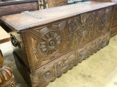 A 17th / 18th century Welsh oak coffer, with carved panelled front and heavy brass strap hinges, W.