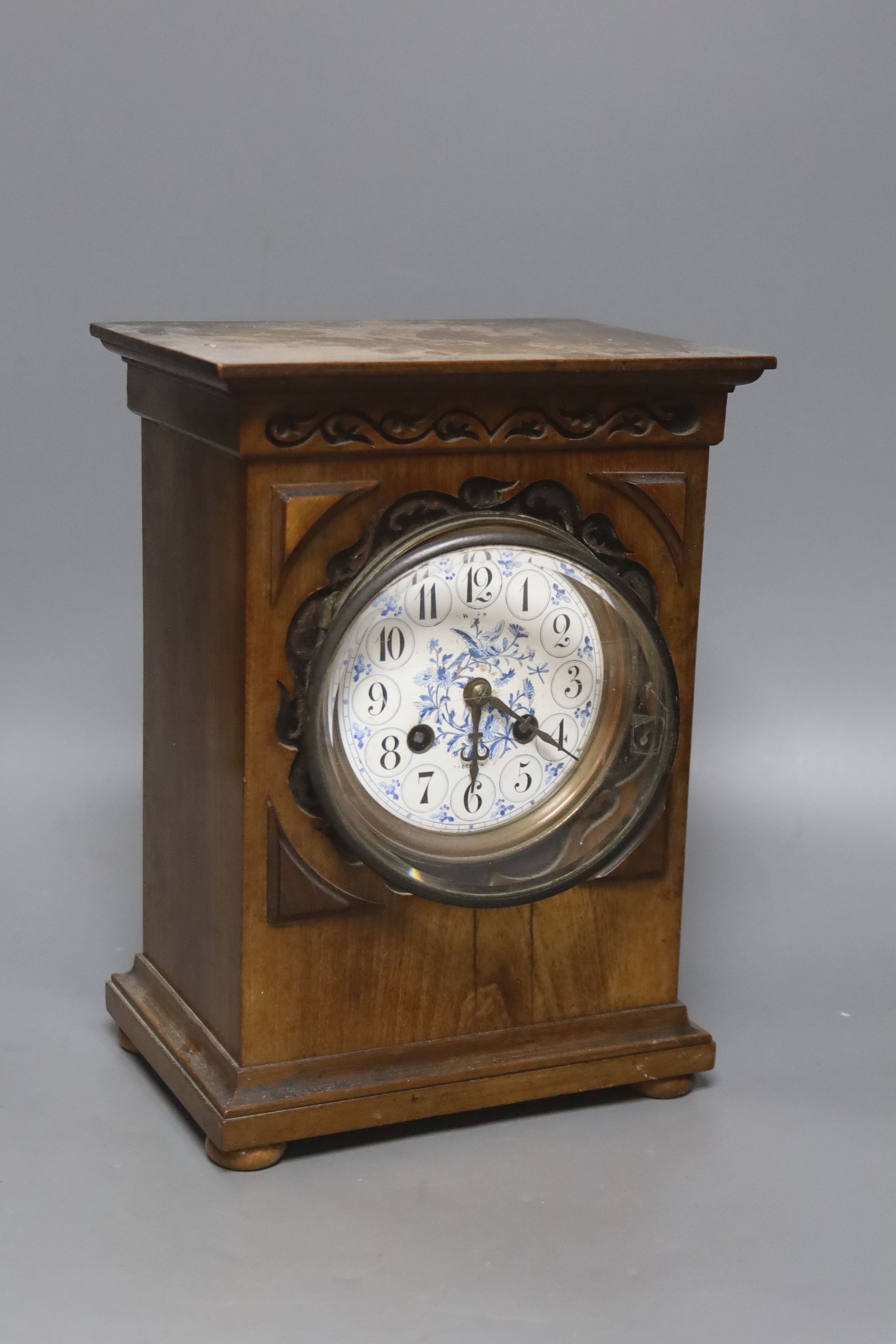 An Edwardian walnut mantel clock, with decorative dial, height 26cm