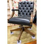 A reproduction beech buttoned blue leather swivel desk chair, W.54cm. D.61cm H.99cm