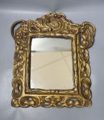 A 19th century gilt composition rectangular mirror in the Baroque style
