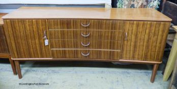 A Gordon Russell Ltd teak and Indian Laurel concave sideboard Model R810 circa 1960, length 183cm,