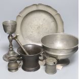 A pewter pedestal bowl, a barbed and crested dish, three other items of pewter and a 17th/18th