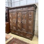 A 17th century and later panelled oak cupboard, length 194cm, depth 70cm, height 198cm