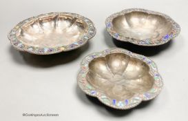 Three Persian white metal and cloisonne enamel small dishes, largest 9.6cm, gross weight 89 grams.