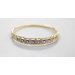 A modern 9ct gold and graduated nine stone amethyst set bracelet, with diamond chip set spacers,