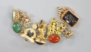 Seven assorted modern yellow metal overlaid and gem set fob seals including two 'spinning' (one